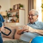 Home health nurse assisting stroke patient with rehabilitation exercises in San Antonio home.